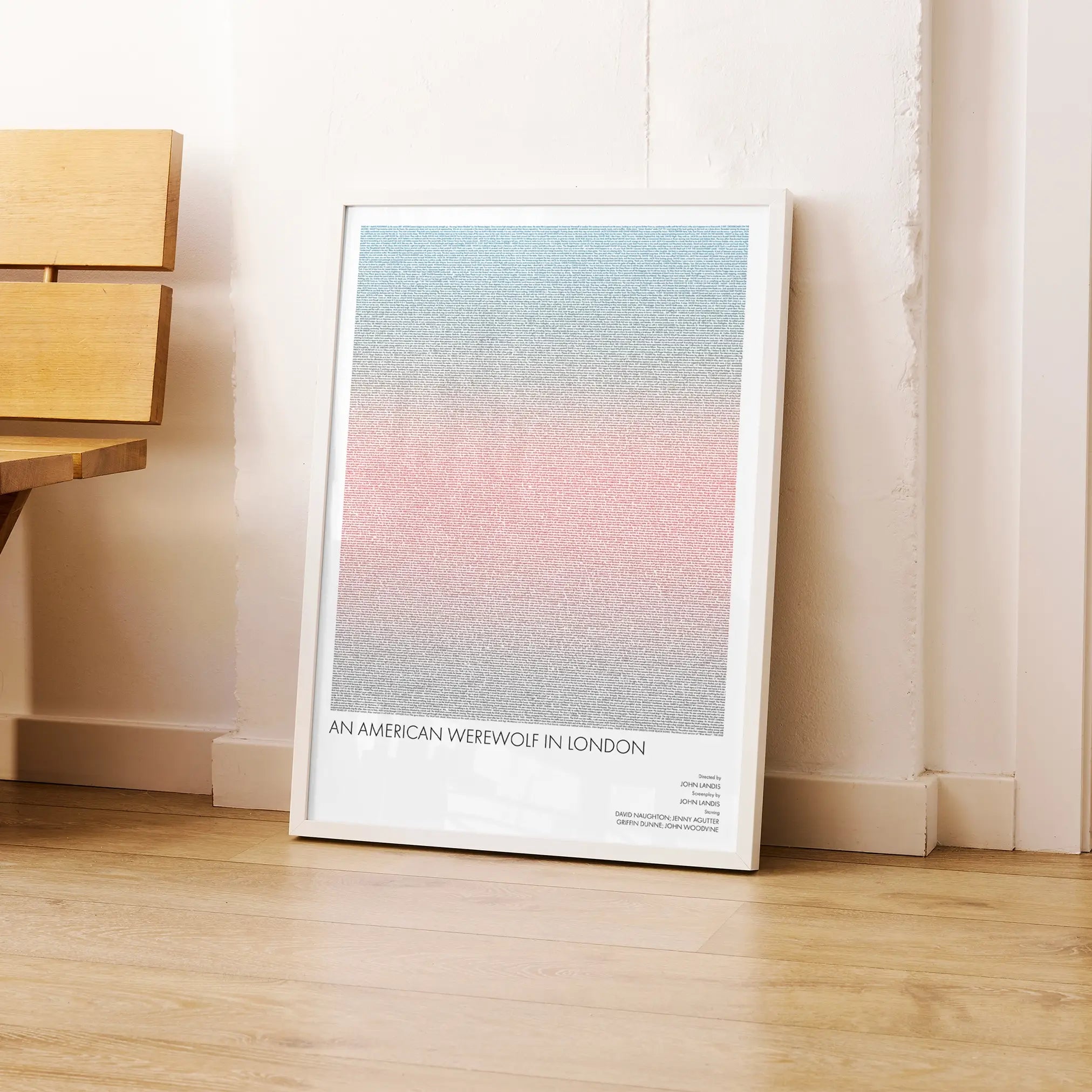 A framed An American Werewolf in London movie script poster leaning against a wall in a modern interior.
