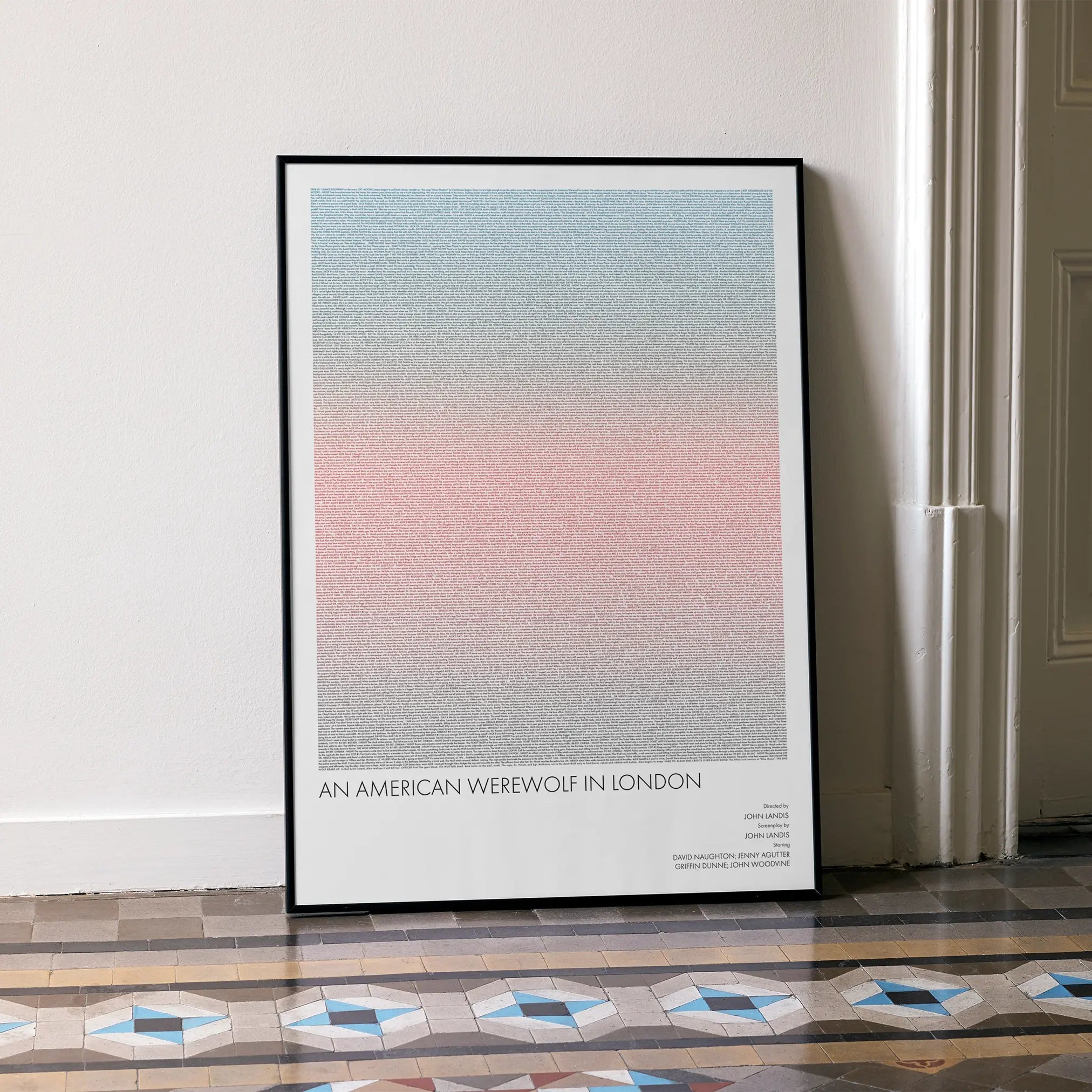 A framed An American Werewolf in London movie script poster leaning against a wall in a minimalist interior.
