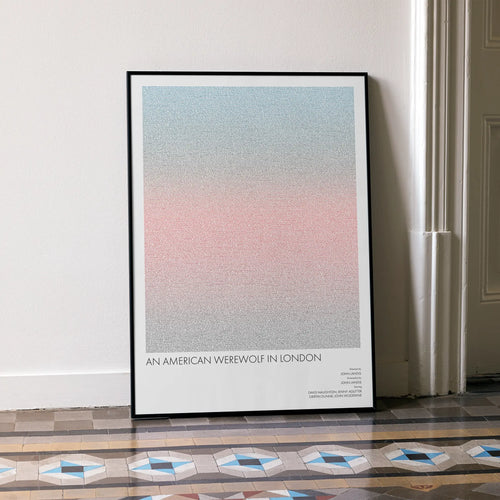A framed An American Werewolf in London movie script poster leaning against a wall in a minimalist interior.