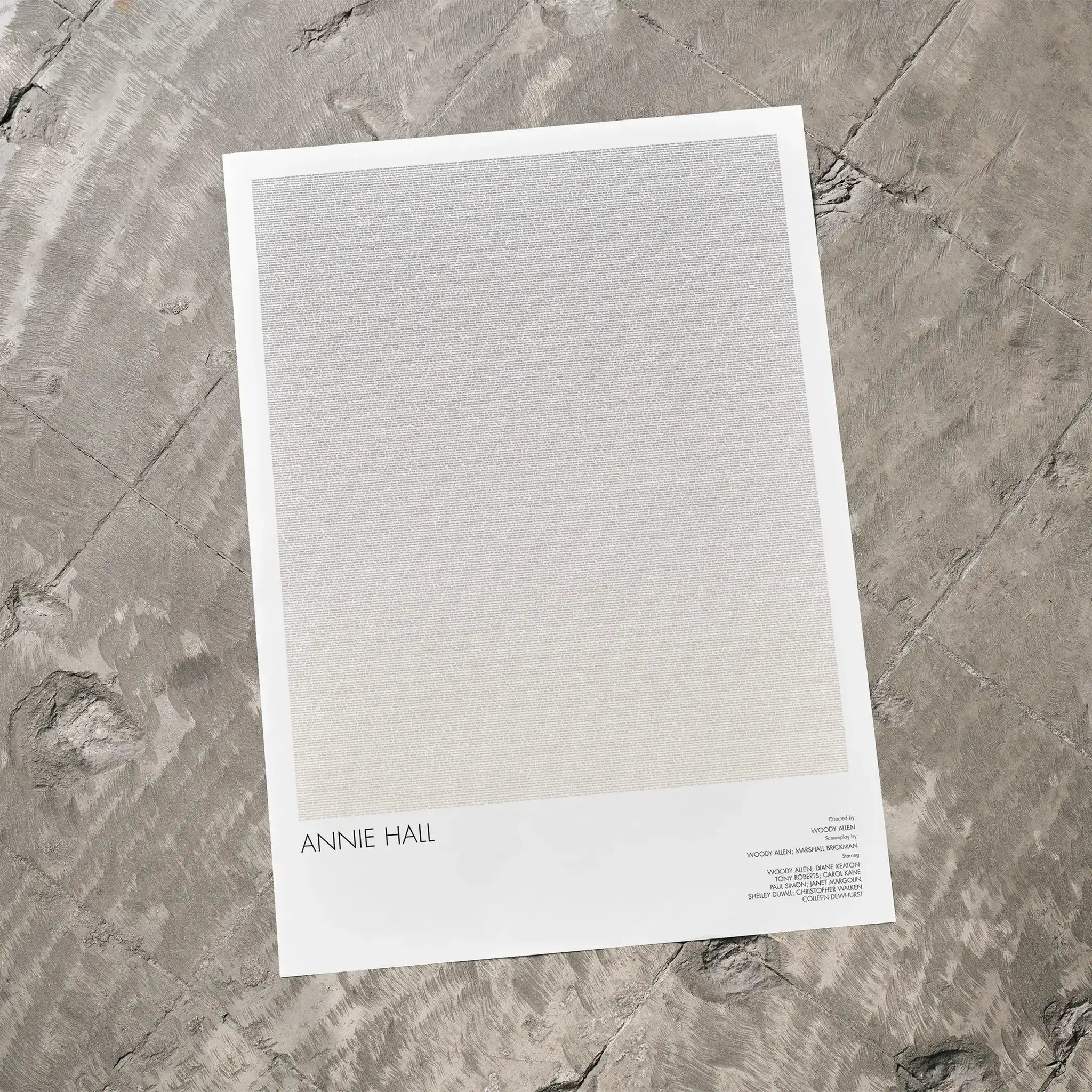 A Annie Hall movie script poster laid flat on a textured floor surface.