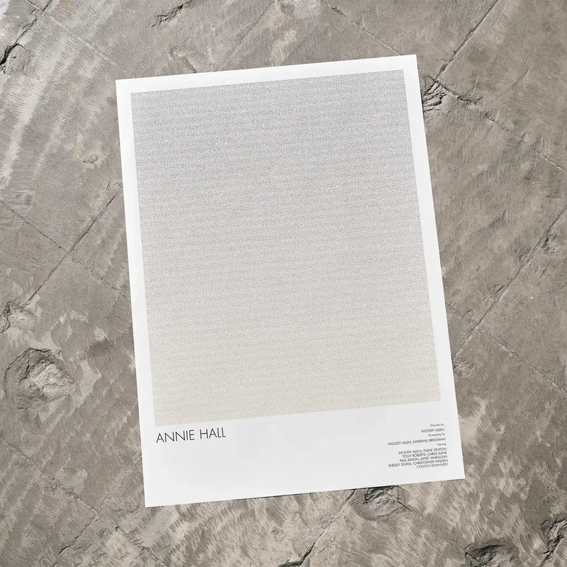 A Annie Hall movie script poster laid flat on a textured floor surface.