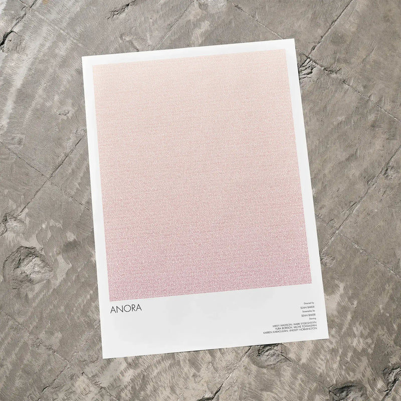 A Anora movie script poster laid flat on a textured floor surface.