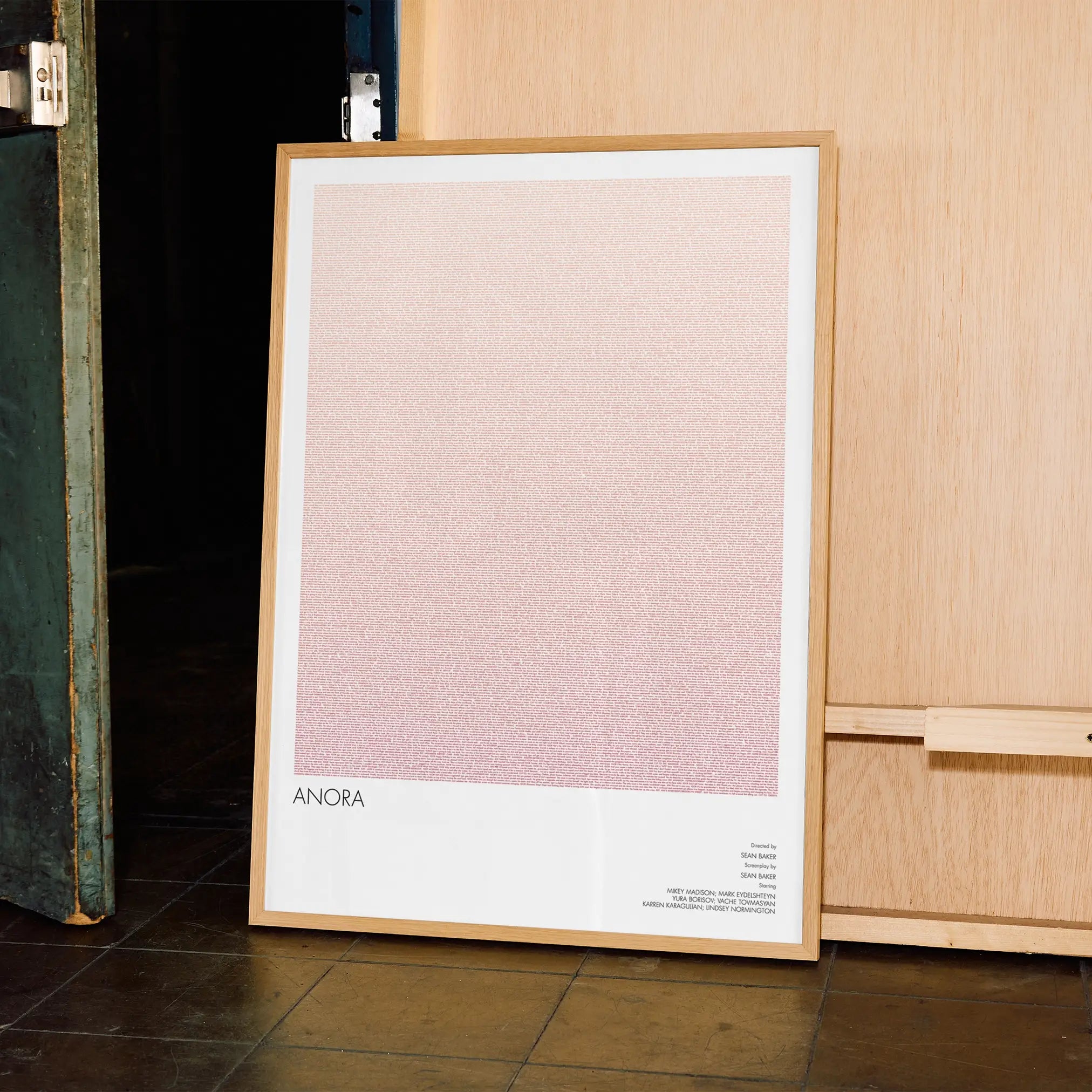 A framed Anora movie script poster displayed in a contemporary interior setting.
