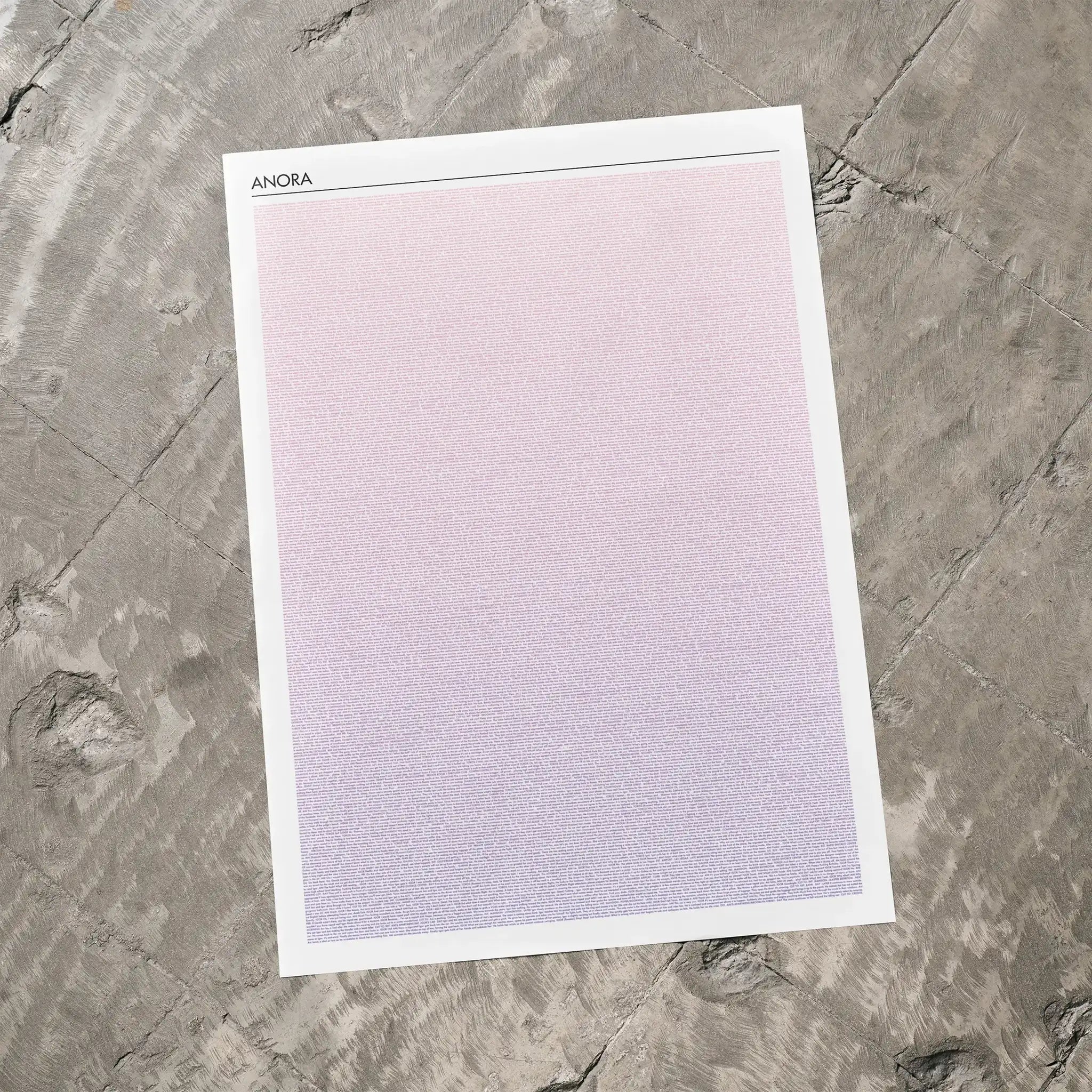A Anora movie script poster laid flat on a textured floor surface.