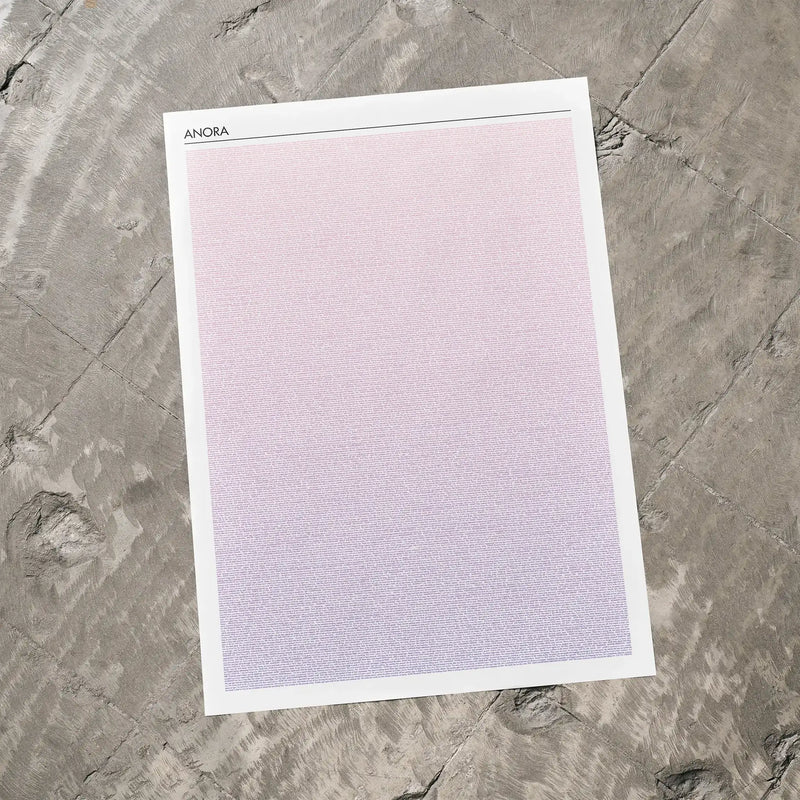 A Anora movie script poster laid flat on a textured floor surface.