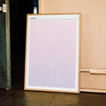 A framed Anora movie script poster displayed in a contemporary interior setting.