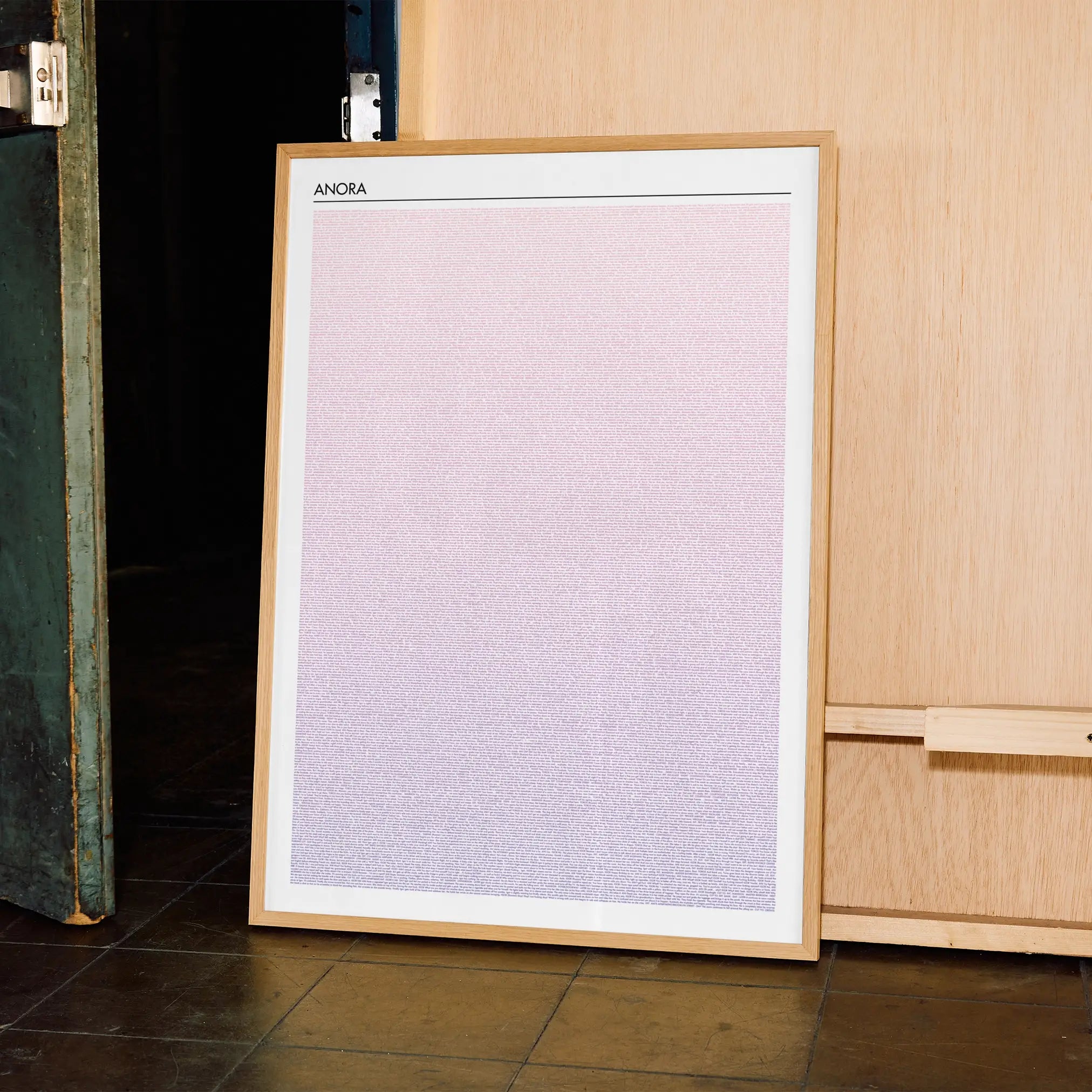 A framed Anora movie script poster displayed in a contemporary interior setting.