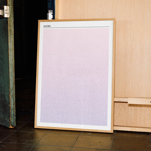 A framed Anora movie script poster displayed in a contemporary interior setting.