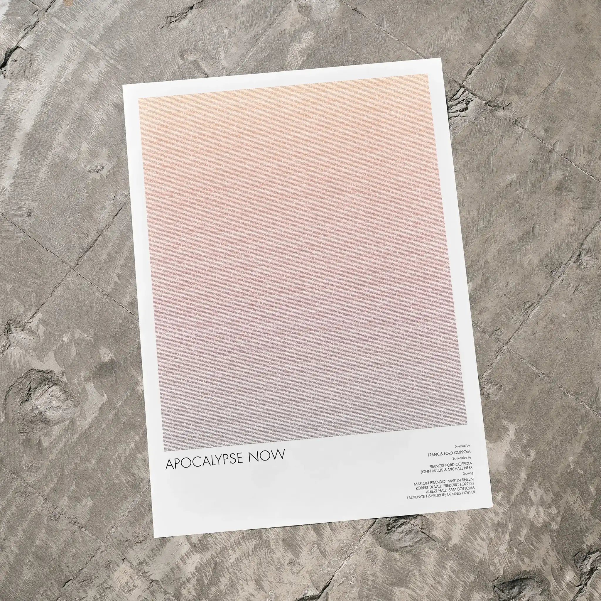 A Apocalypse Now movie script poster laid flat on a textured floor surface.