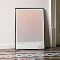 A framed Apocalypse Now movie script poster leaning against a wall in a minimalist interior.