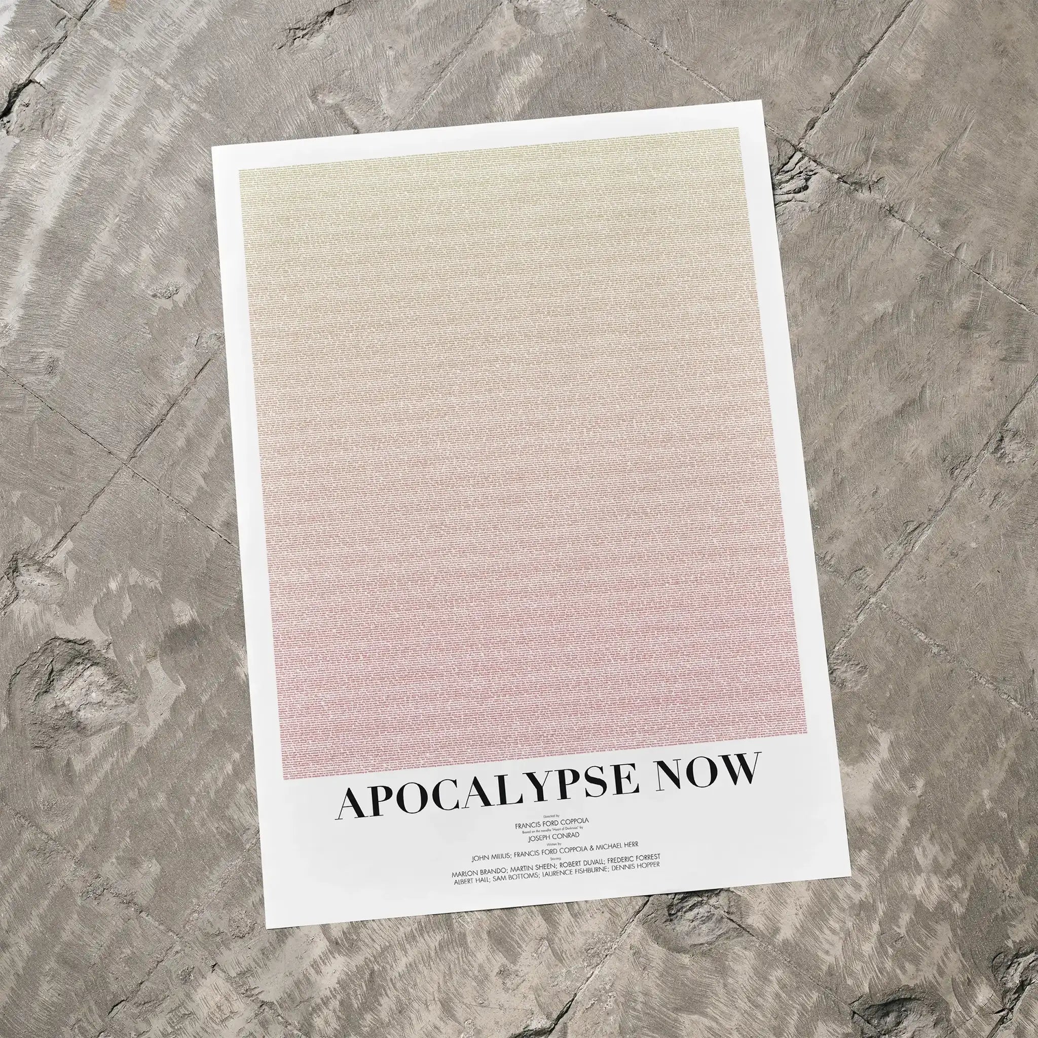 A Apocalypse Now movie script poster laid flat on a textured floor surface.
