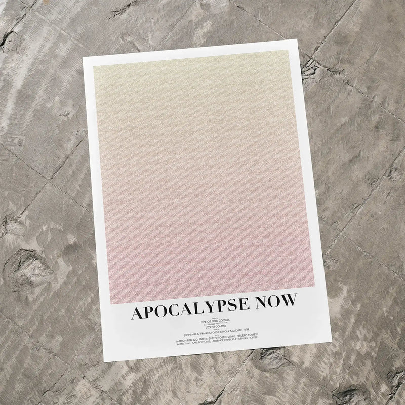 A Apocalypse Now movie script poster laid flat on a textured floor surface.