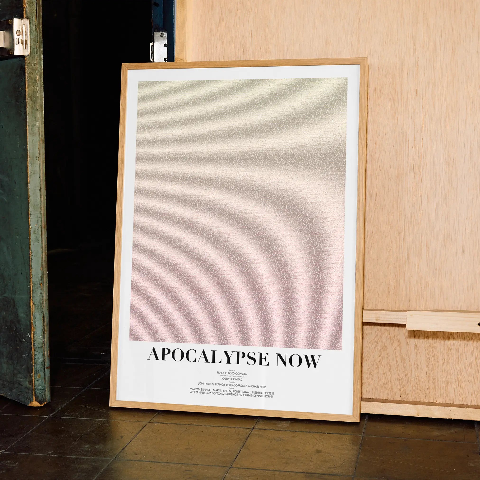 A framed Apocalypse Now movie script poster displayed in a contemporary interior setting.