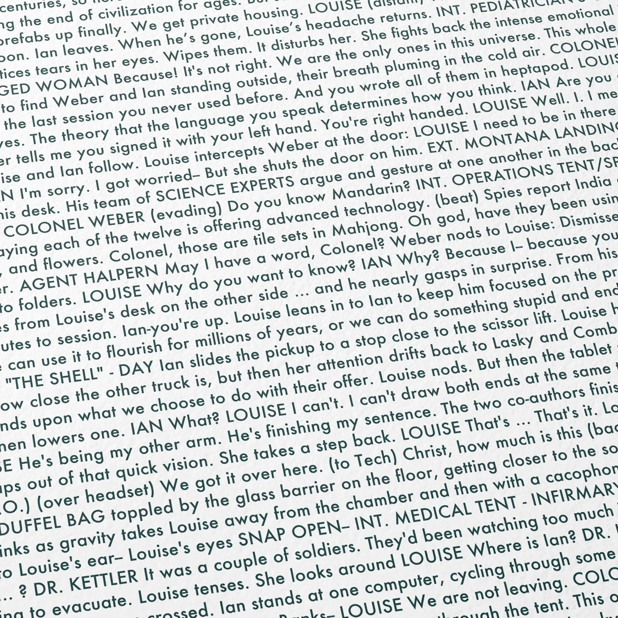 Close-up detail of the Arrival movie script poster showing dense typographic text.