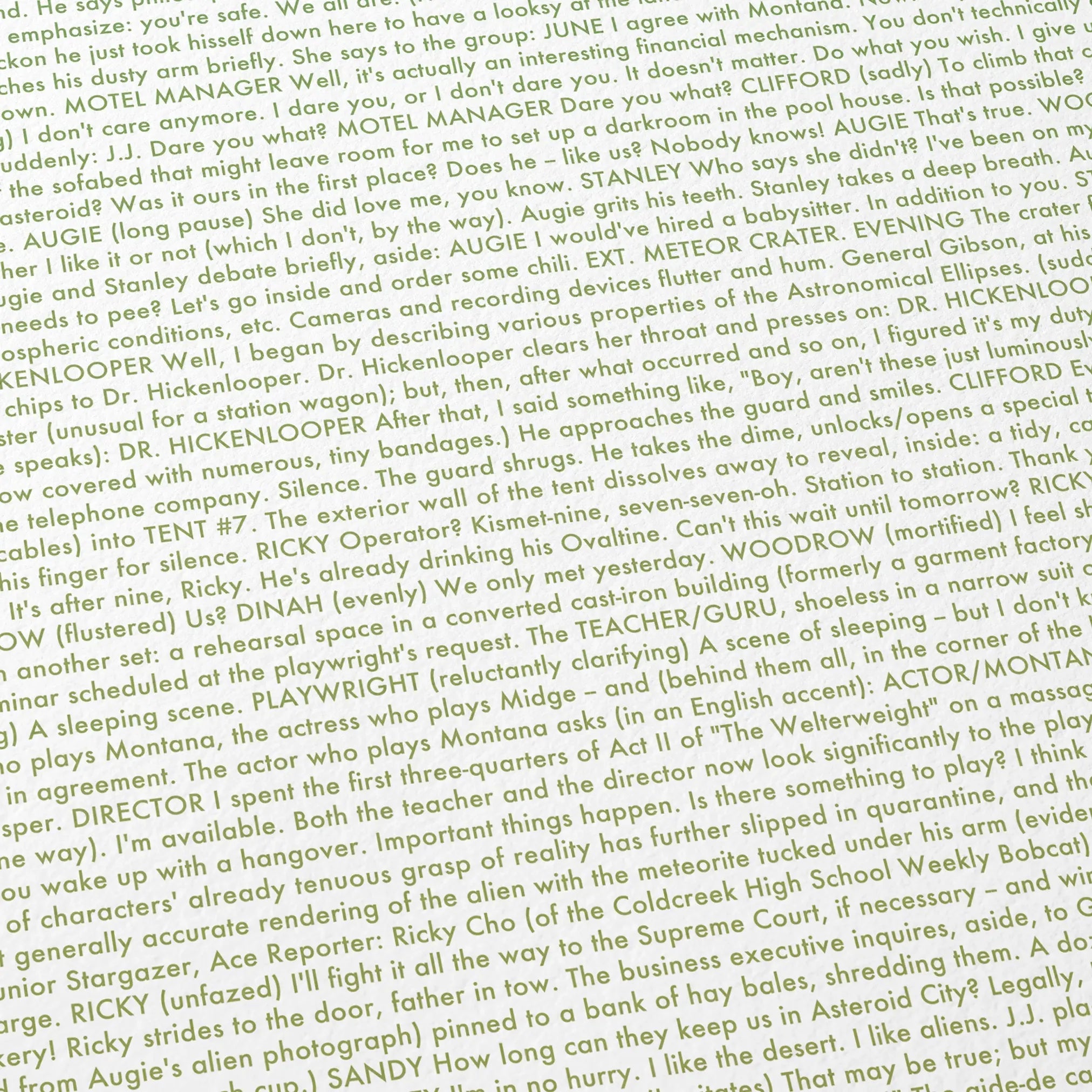 Close-up detail of the Asteroid City movie script poster showing dense typographic text.