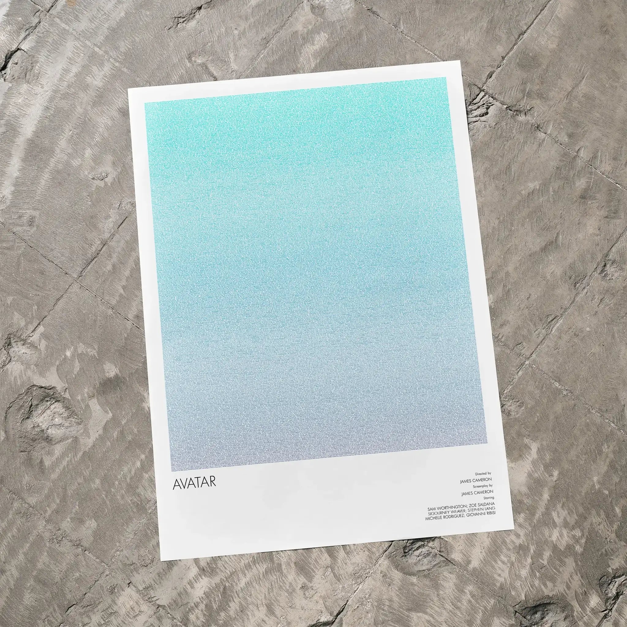 A Avatar movie script poster laid flat on a textured floor surface.