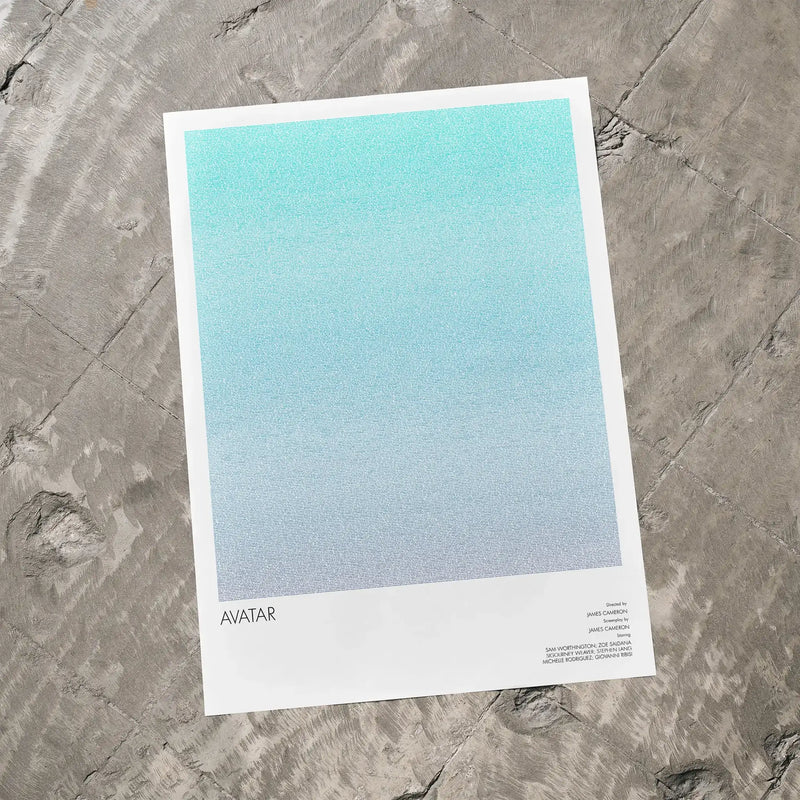 A Avatar movie script poster laid flat on a textured floor surface.