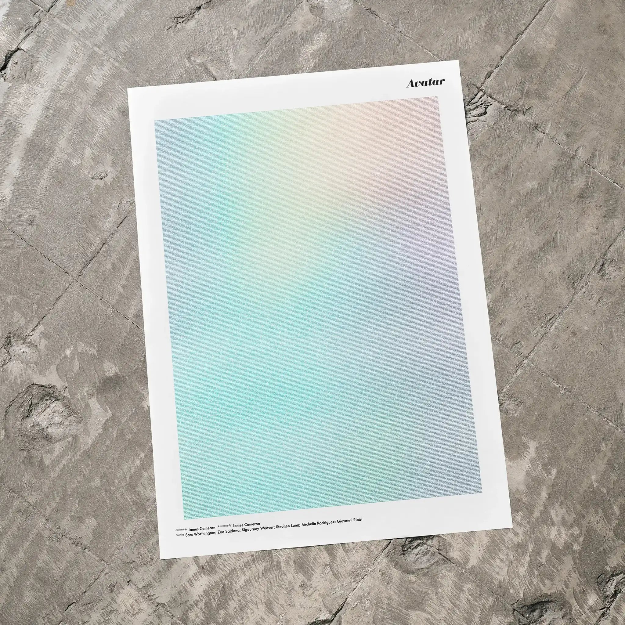 A Avatar movie script poster laid flat on a textured floor surface.