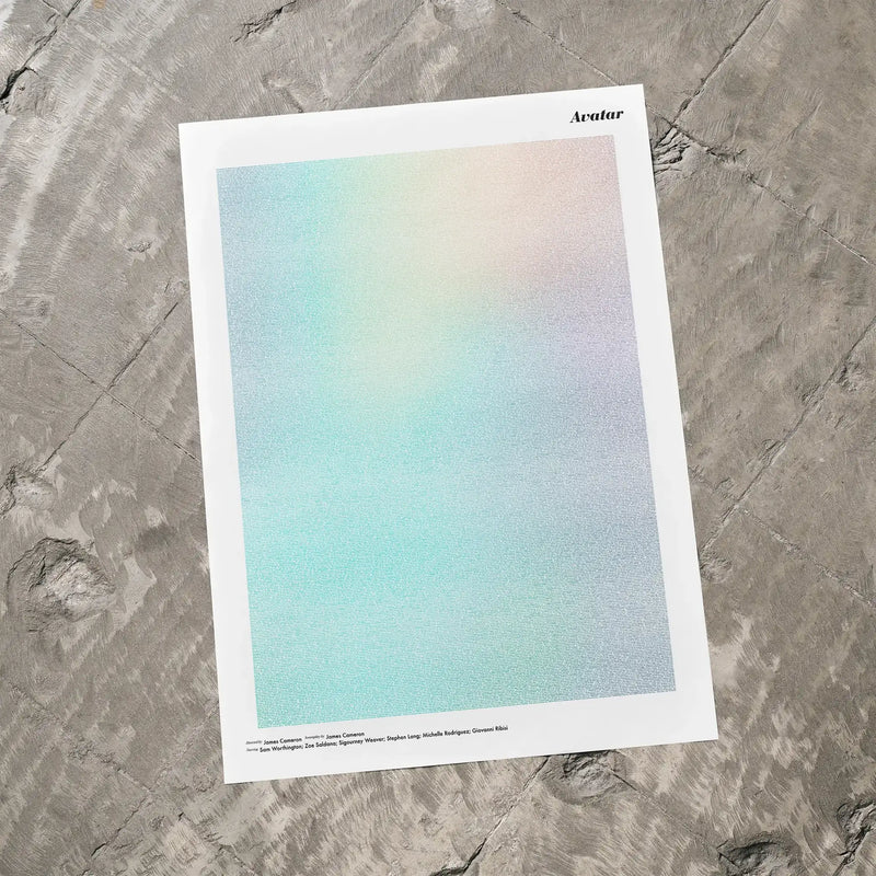 A Avatar movie script poster laid flat on a textured floor surface.