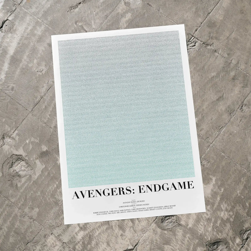 A Avengers: Endgame movie script poster laid flat on a textured floor surface.