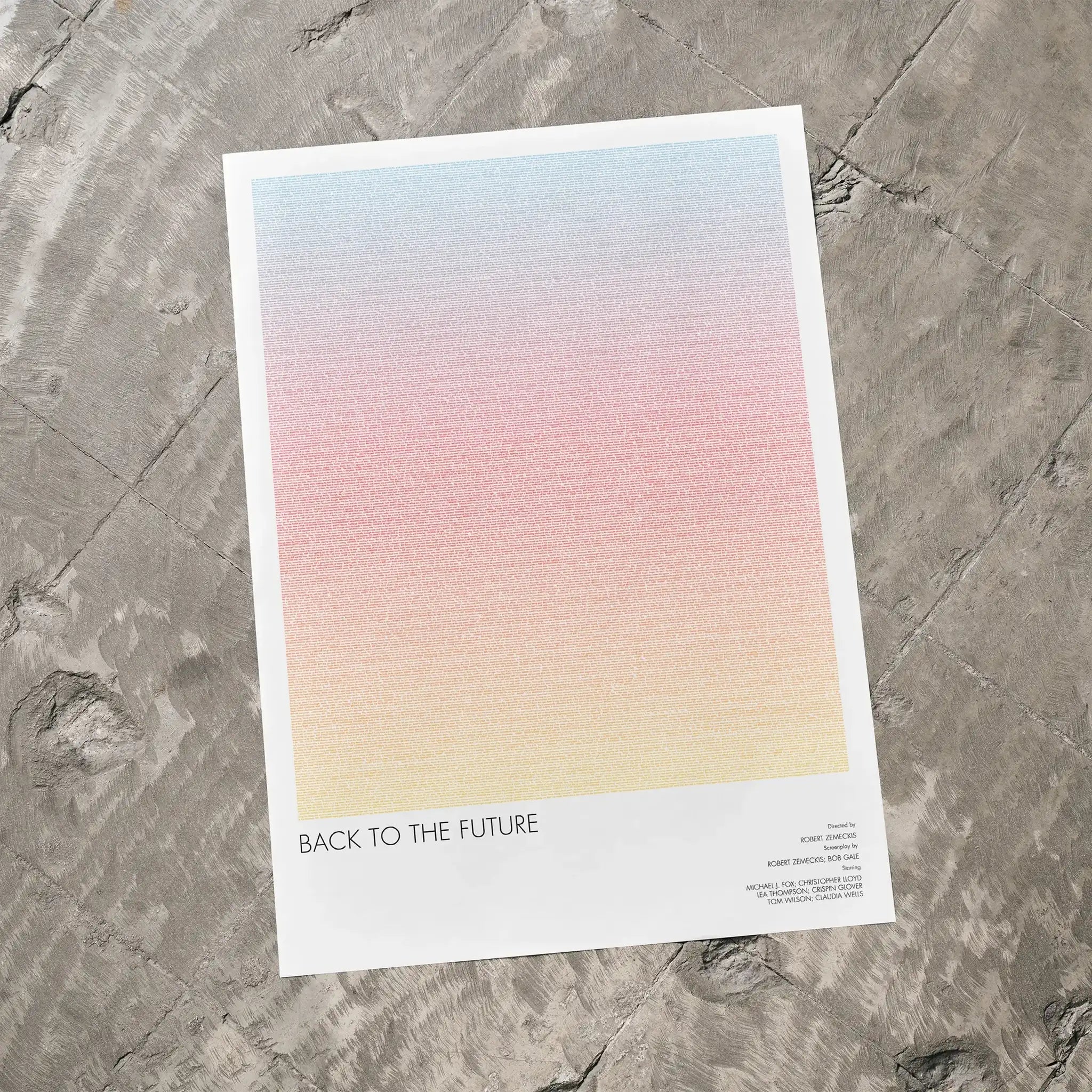 A Back to the Future movie script poster laid flat on a textured floor surface.