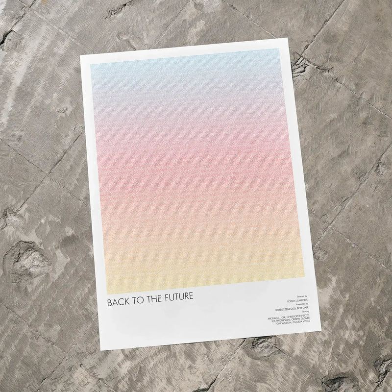 A Back to the Future movie script poster laid flat on a textured floor surface.