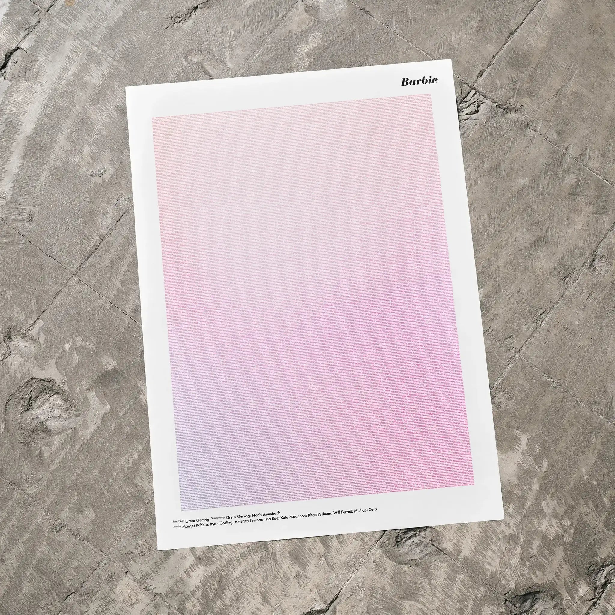 A Barbie movie script poster laid flat on a textured floor surface.