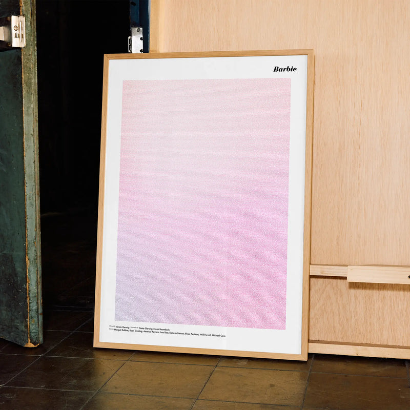A framed Barbie movie script poster displayed in a contemporary interior setting.