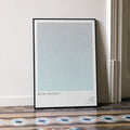 A framed Before Midnight movie script poster leaning against a wall in a minimalist interior.