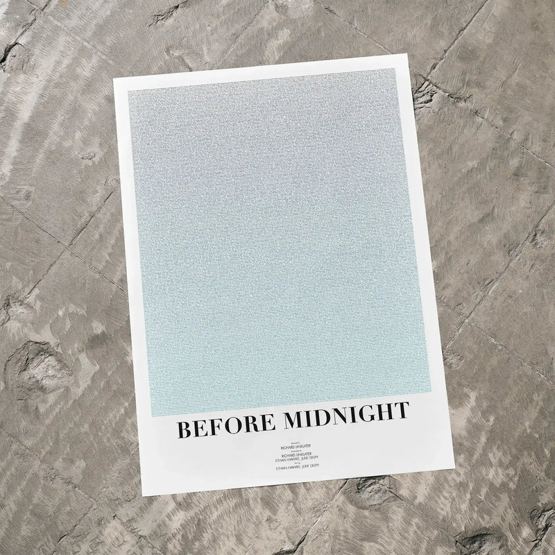 A Before Midnight movie script poster laid flat on a textured floor surface.