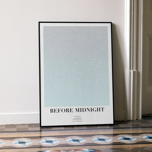 A framed Before Midnight movie script poster leaning against a wall in a minimalist interior.