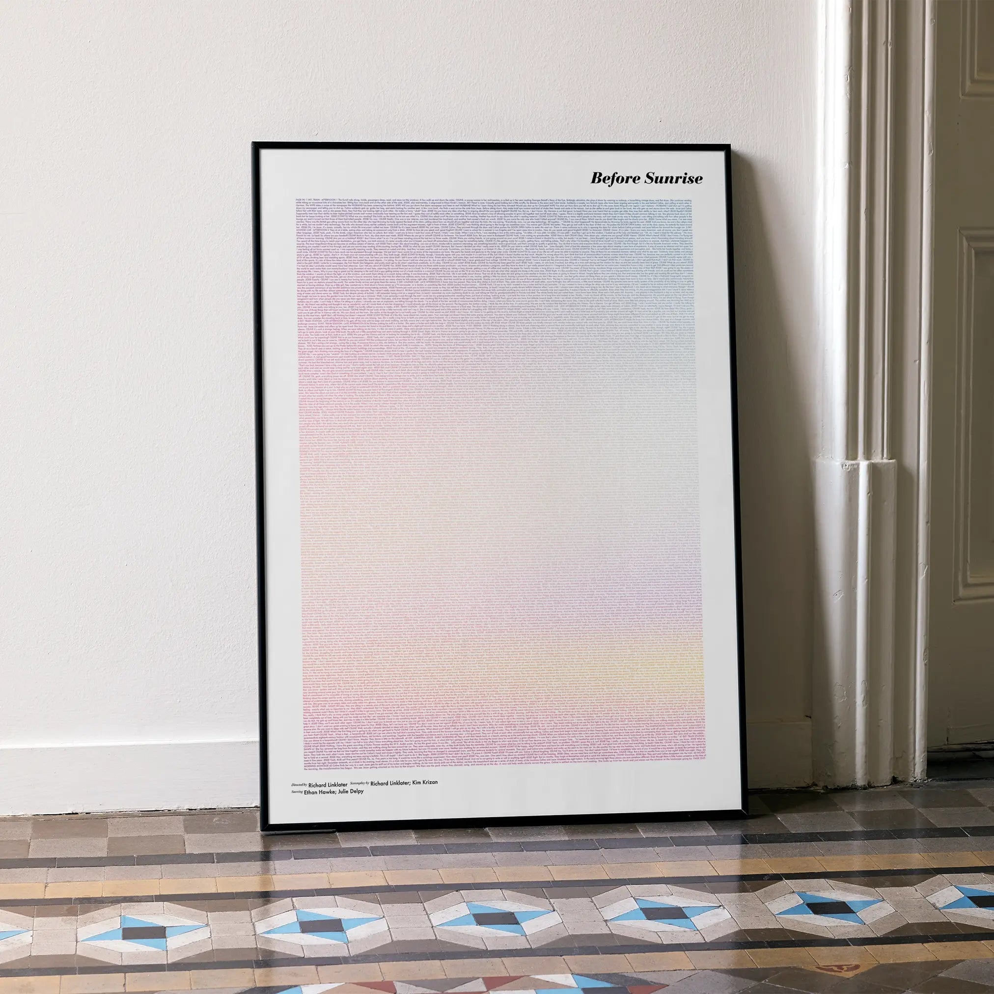 A framed Before Sunrise movie script poster leaning against a wall in a minimalist interior.