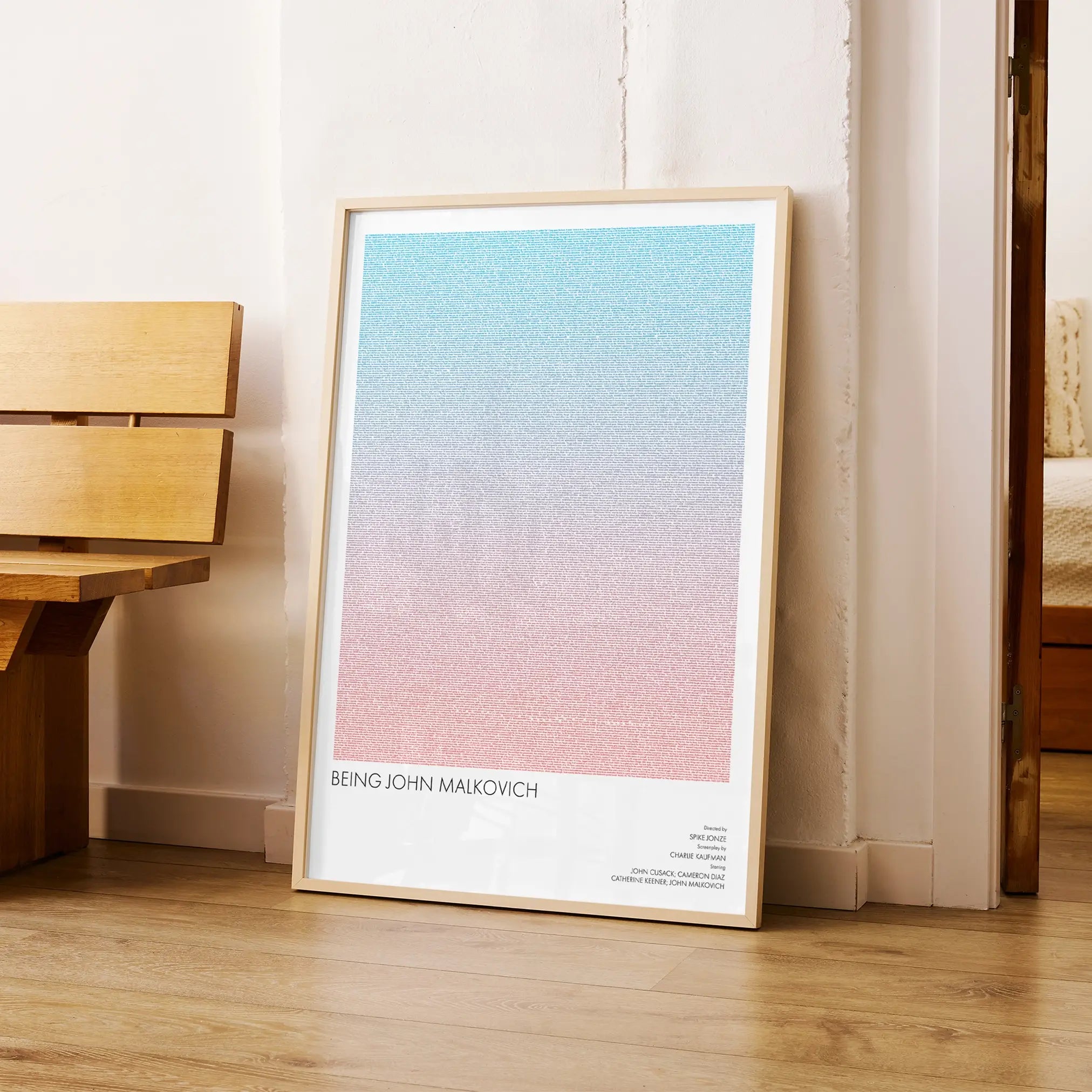 A framed Being John Malkovich movie script poster arranged in a minimalist interior setting.