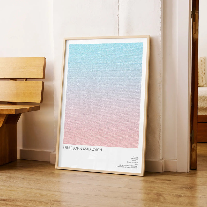 A framed Being John Malkovich movie script poster arranged in a minimalist interior setting.