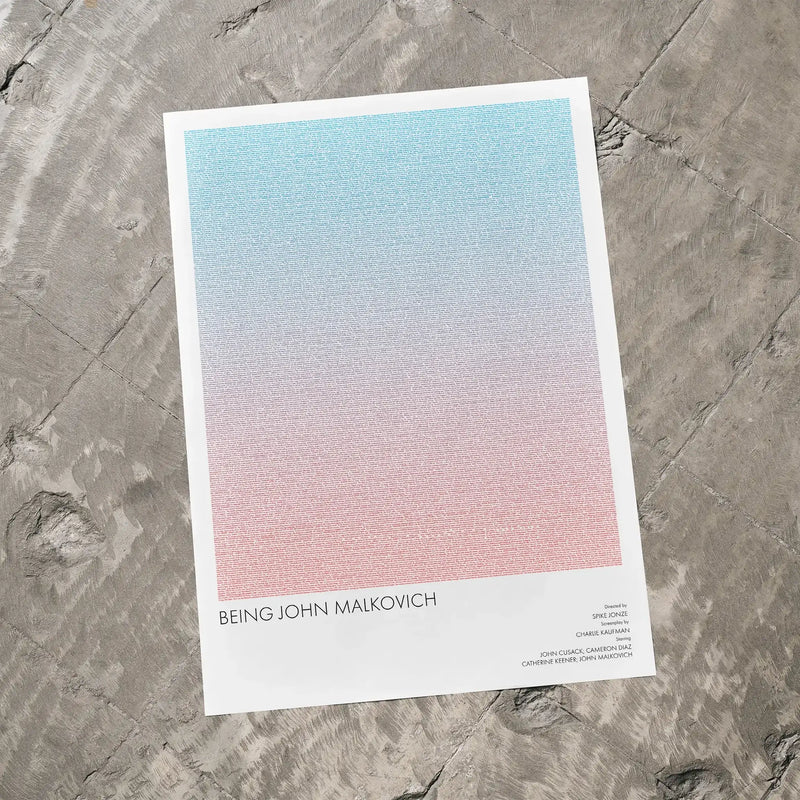 A Being John Malkovich movie script poster laid flat on a textured floor surface.