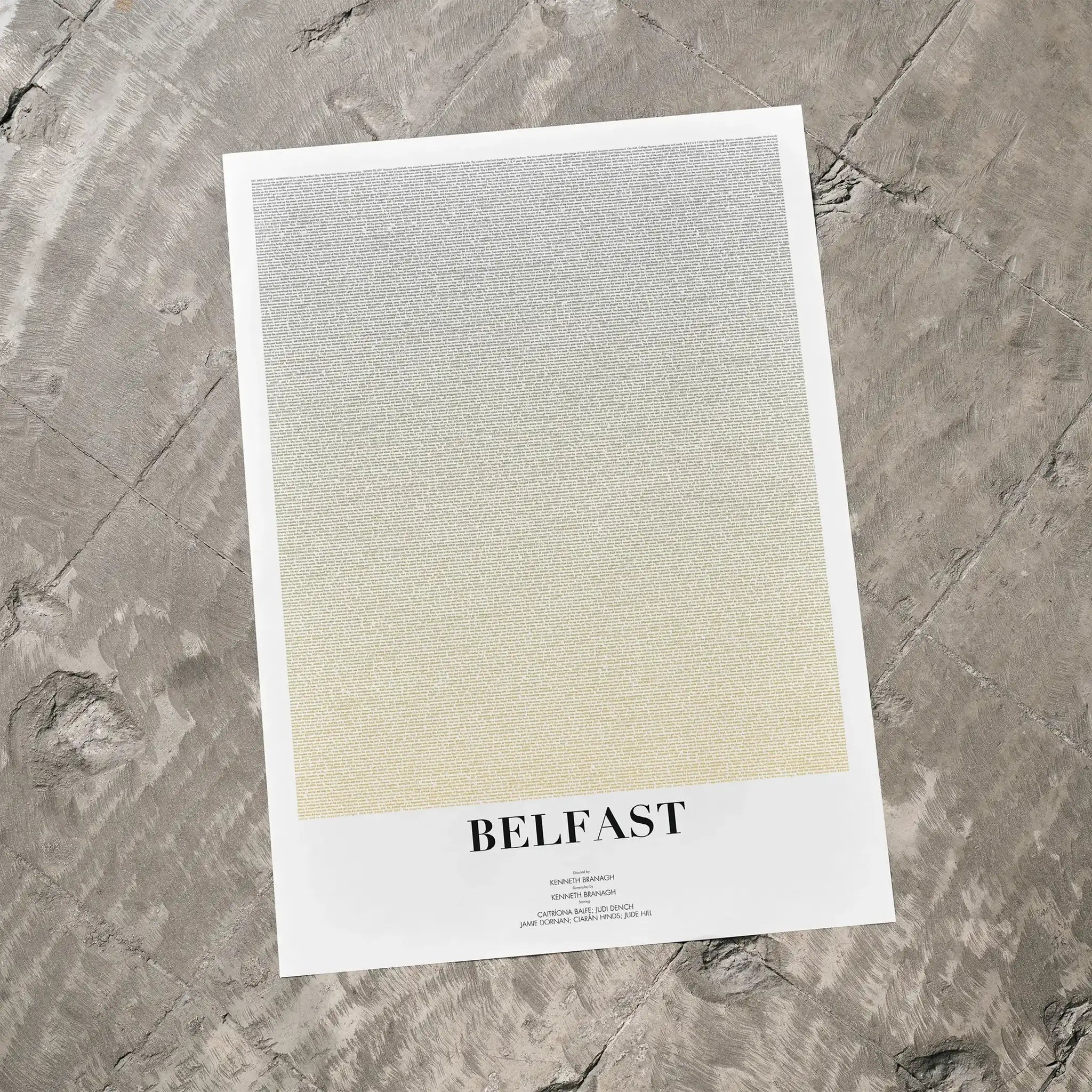 A Belfast movie script poster laid flat on a textured floor surface.