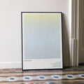 A framed Birdman or movie script poster leaning against a wall in a minimalist interior.