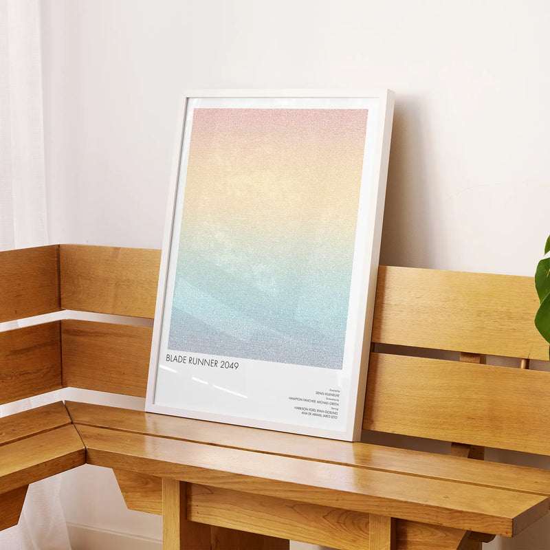 A framed Blade Runner 2049 movie script poster displayed on a sideboard in a contemporary space.