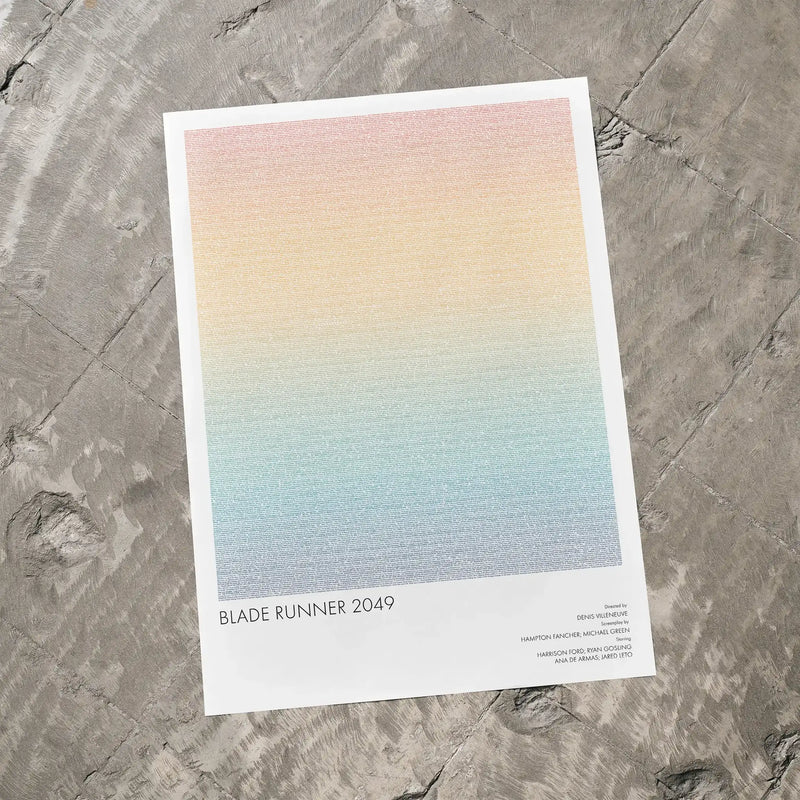 A Blade Runner 2049 movie script poster laid flat on a textured floor surface.