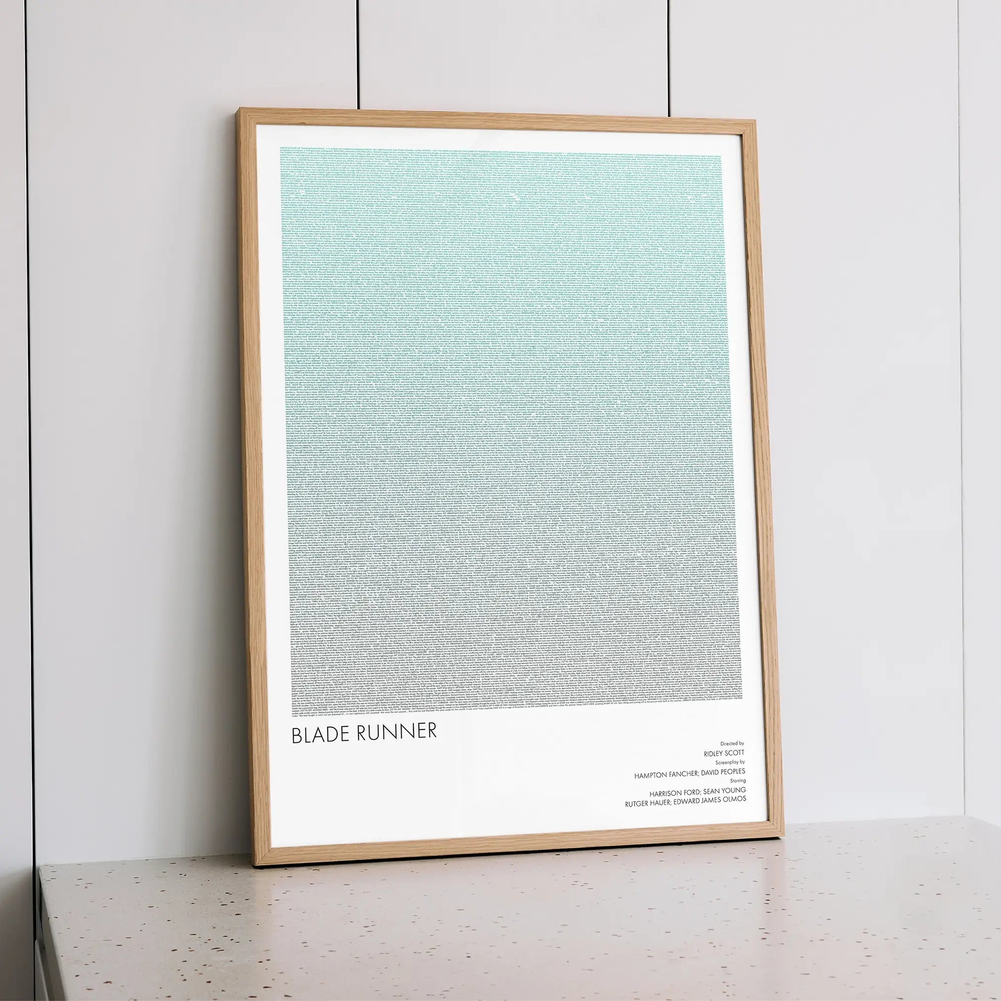 A framed Blade Runner movie script poster styled within a calm interior space.