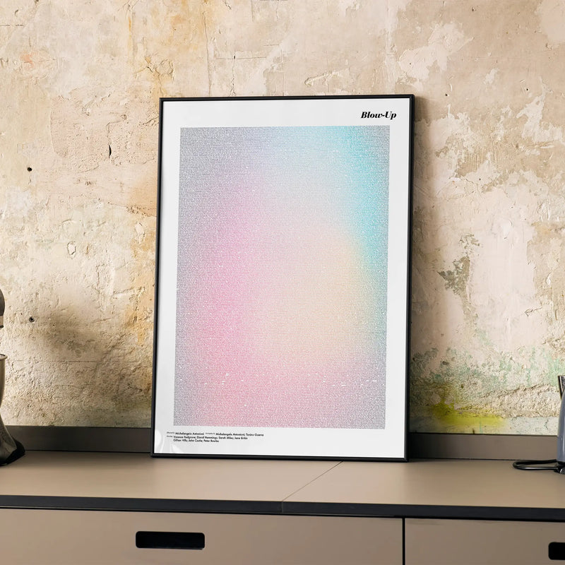A framed Blow-Up movie script poster displayed on a cabinet in a minimalist interior.