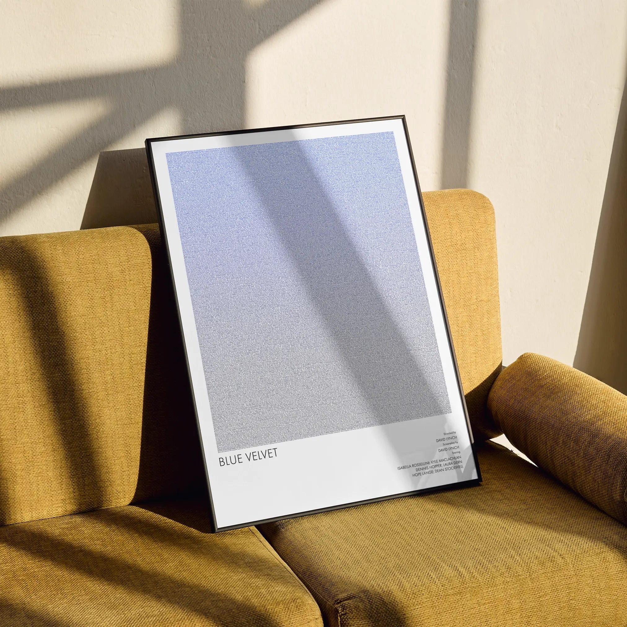 A framed Blue Velvet movie script poster styled in a clean interior setting.