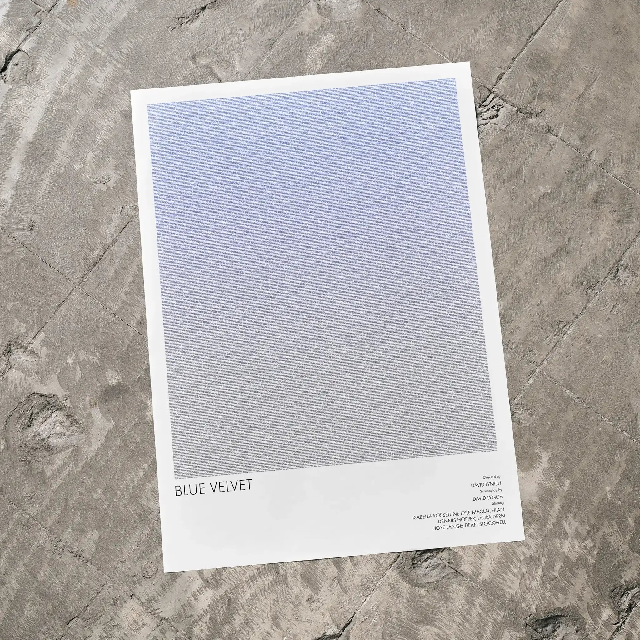A Blue Velvet movie script poster laid flat on a textured floor surface.