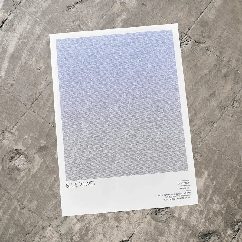 A Blue Velvet movie script poster laid flat on a textured floor surface.