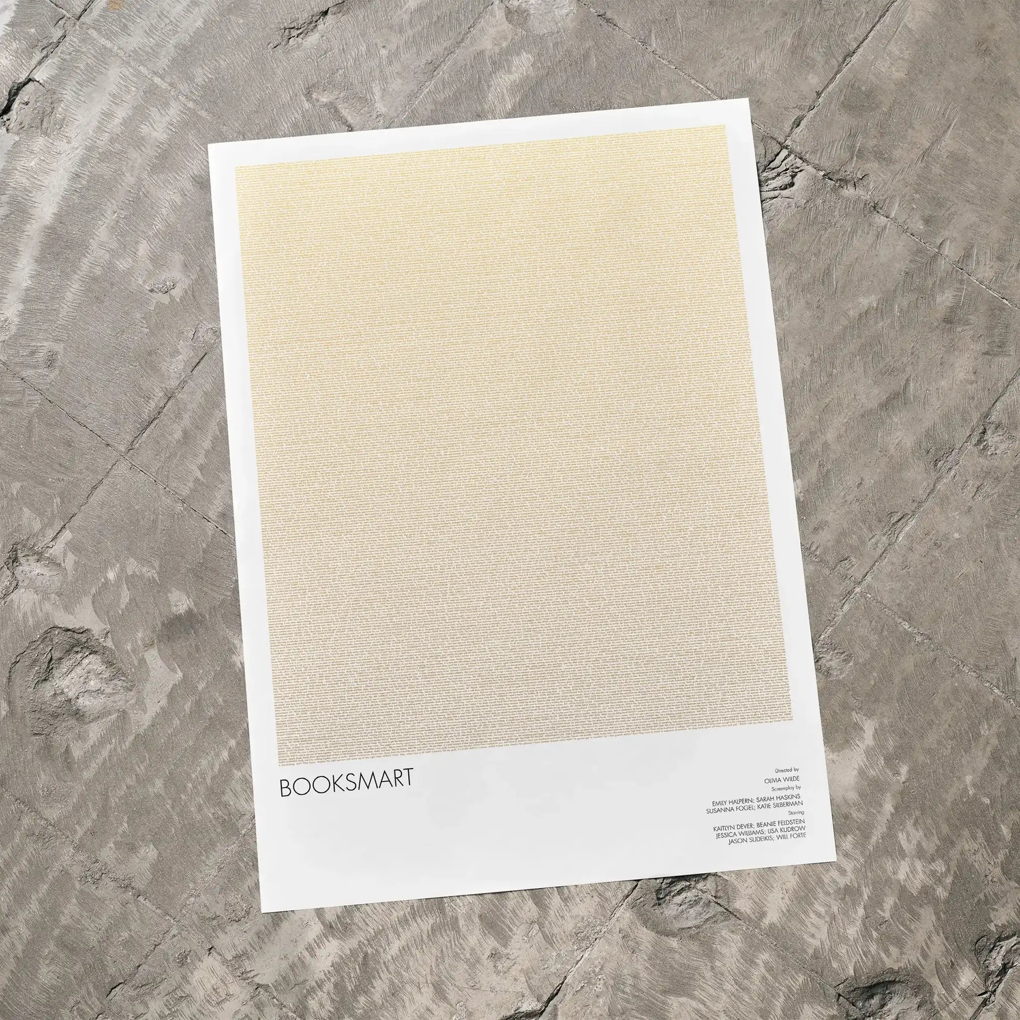 A Booksmart movie script poster laid flat on a textured floor surface.