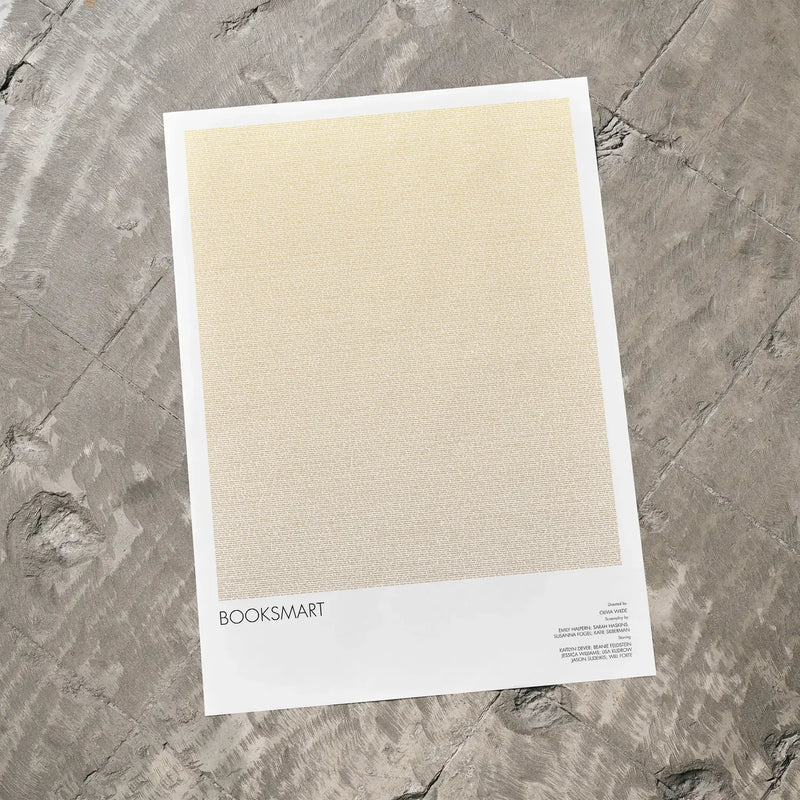 A Booksmart movie script poster laid flat on a textured floor surface.