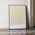 A framed Booksmart movie script poster leaning against a wall in a minimalist interior.