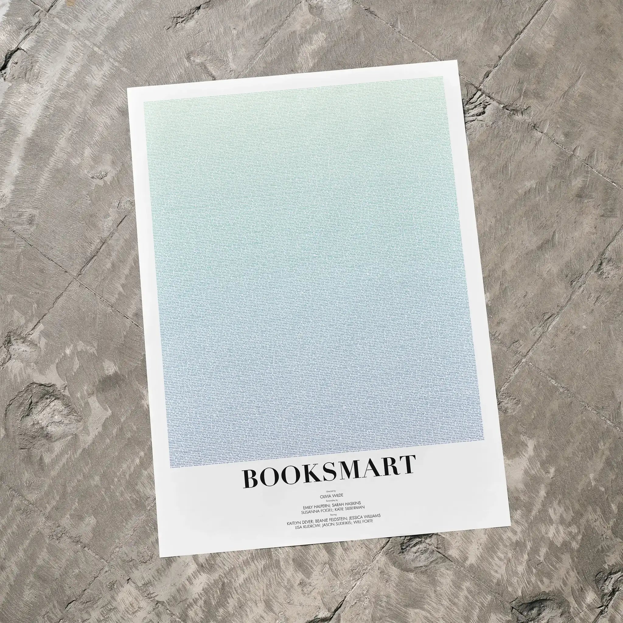 A Booksmart movie script poster laid flat on a textured floor surface.