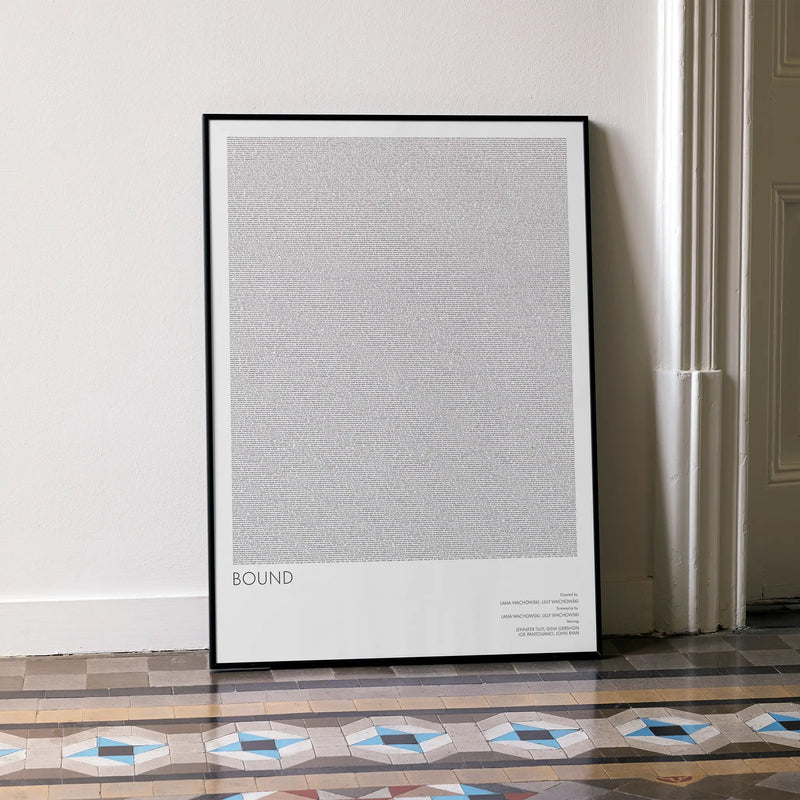Framed 'Bound' movie poster with text on a wall in a room with patterned floor.