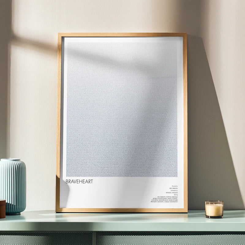 A framed Braveheart movie script poster displayed in a simple modern interior.